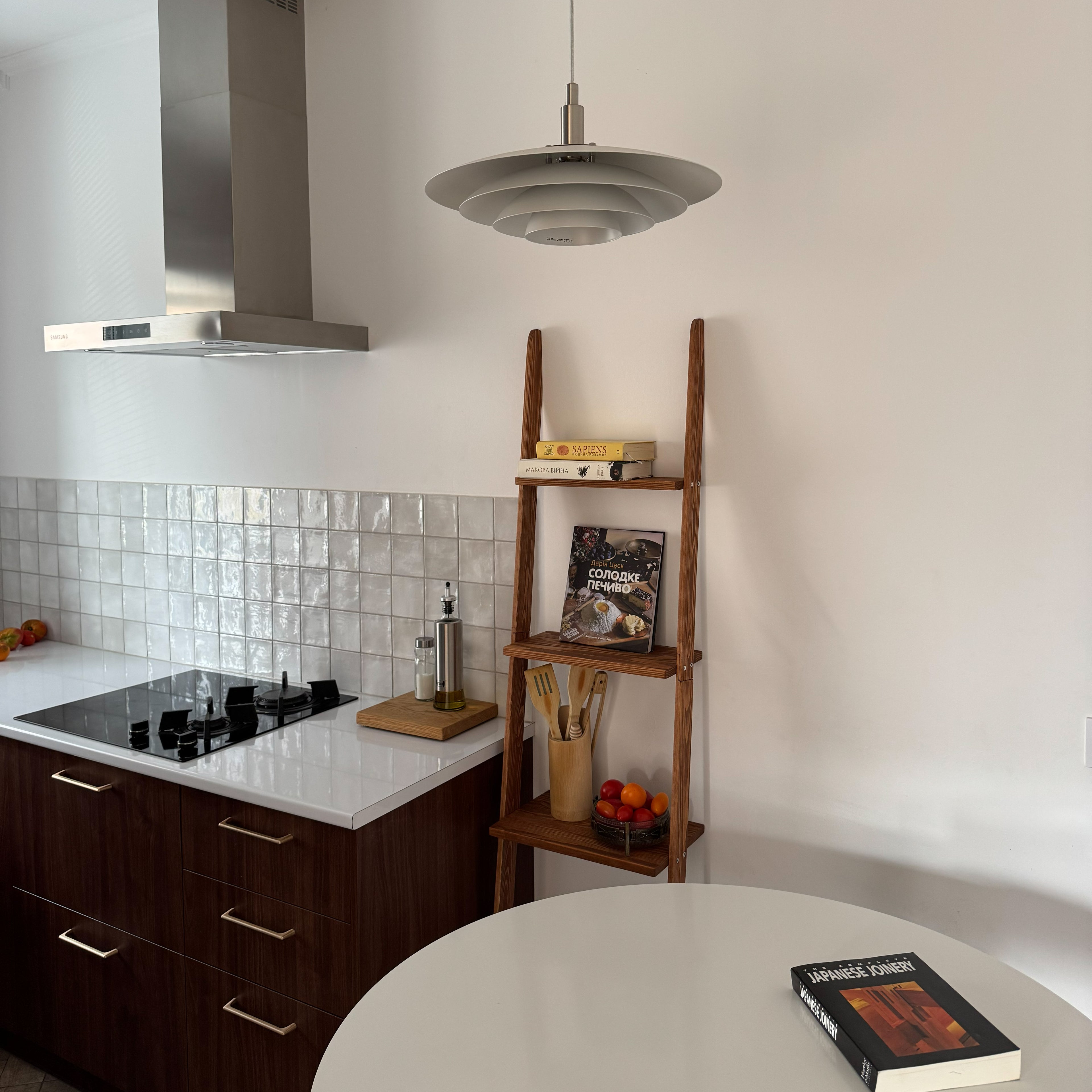 Modern kitchen with wooden shelf against a white wall